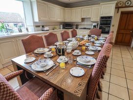 A kitchen with a dining table set for breakfast at Farmhouse in Beccles