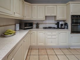 A kitchen with cabinets and appliances at Farmhouse in Beccles