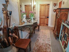 A hallway with decorative items and furniture at Farmhouse in Beccles