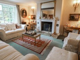 A living room with a fireplace and sofa at Farmhouse in Beccles