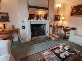 A living room with a fireplace and coffee table at Farmhouse in Beccles