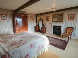 A bedroom with a bed and wardrobe at the Farmhouse in Beccles