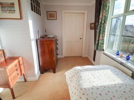 A bedroom with a bed and furniture at Farmhouse in Beccles