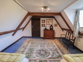 A bedroom with furniture and a rug at the Farmhouse in Beccles