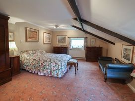 A bedroom with a bed and furniture at the Farmhouse in Beccles