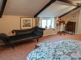 A bedroom with a sofa and bed at the Farmhouse in Beccles