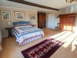 A bedroom with a bed and furniture at Farmhouse in Beccles