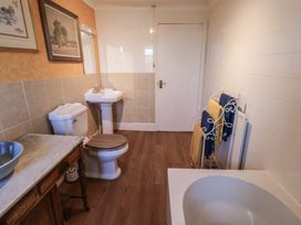 A bathroom with a toilet and wash basin at Farmhouse in Beccles