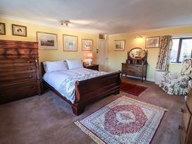 A bedroom with a bed and dresser at Farmhouse in Beccles