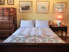 A bedroom with a bed and nightstand at Farmhouse in Beccles