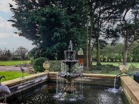 A fountain with water in a garden at Farmhouse in Beccles