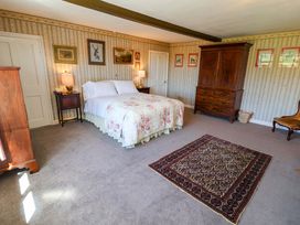 A bedroom with a bed and wardrobe at Winston Hall in Beccles