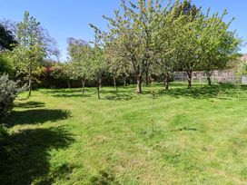 A garden with trees and grass at Winston Hall in Beccles