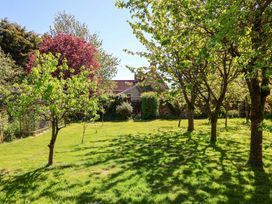 A garden with trees and a gate at Winston Hall in Beccles