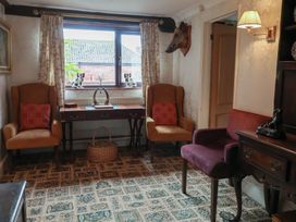 A snug with chairs and a table at Winston Lodge in Beccles