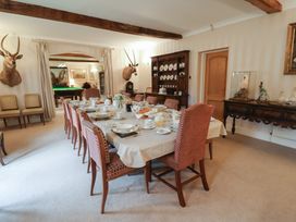 A dining room with a table set for a meal at Winston Lodge in Beccles