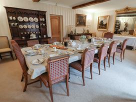 A dining room with a table set for a meal at Winston Lodge in Beccles