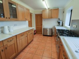 A kitchen with cabinets and a stove at Winston Lodge in Beccles