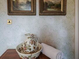 A pitcher and bowl with a towel at Winston Lodge in Beccles