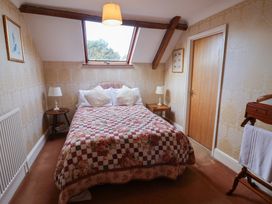 A bedroom with a bed and a table at Winston Lodge in Beccles
