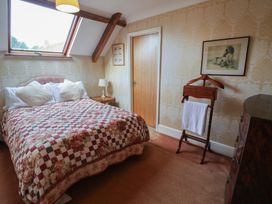 A bedroom with a bed and a towel rack at Winston Lodge in Beccles