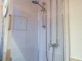 A shower with a faucet and showerhead at Winston Lodge in Beccles