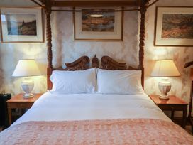 A bedroom with a bed and bedside tables at The Gun Room in Beccles