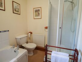 A bathroom with a bathtub, shower, and toilet at The Gun Room in Beccles