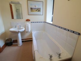 A bathroom with a bathtub and sink at The Gun Room in Beccles