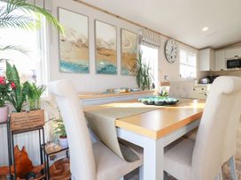 A dining room with a table and chairs at FW4 (Fairways 4)