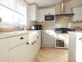 A kitchen with cabinets, a sink, and appliances at FW4 (Fairways 4)