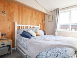 A bedroom with a bed and a nightstand at FW4 (Fairways 4)