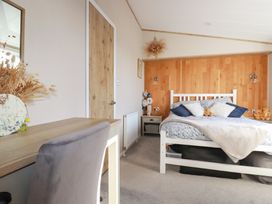 A bedroom with a bed and desk at FW4 (Fairways 4)