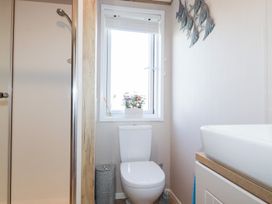 A bathroom with a toilet and shower at FW4 (Fairways 4)