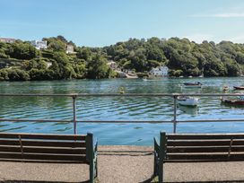 A view of water with boats and houses from a bench at FW4 (Fairways 4) Doublebois near Dobwalls