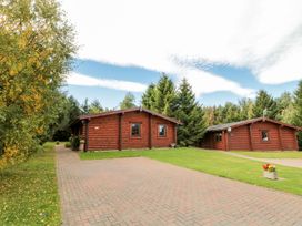Three cabins surrounded by trees at Little Bears Hideaway @ 23 Lakeside Felmoor Park near Felton
