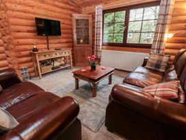 A living room with a television and seating area at Little Bears Hideaway @ 23 Lakeside Felmoor Park near Felton