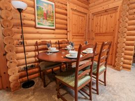 A dining room with a table and four chairs at Little Bears Hideaway @ 23 Lakeside, Felmoor Park near Felton
