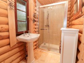 A bathroom with a shower and sink at Little Bears Hideaway @ 23 Lakeside, Felmoor Park near Felton