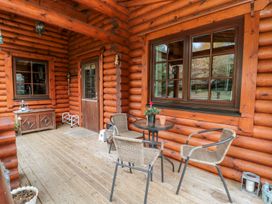 Outdoor seating area with a table and chairs at Little Bears Hideaway @ 23 Lakeside Felmoor Park near Felton