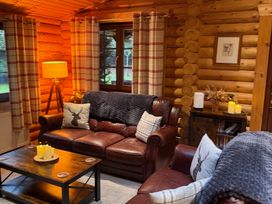 A living room with a sofa and coffee table at Little Bears Hideaway @ 23 Lakeside Felmoor Park near Felton