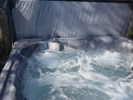 A hot tub with bubbles and water at Little Bears Hideaway @ 23 Lakeside Felmoor Park near Felton