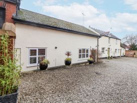 An exterior view of a building with windows and plants at The Stables in Prestatyn