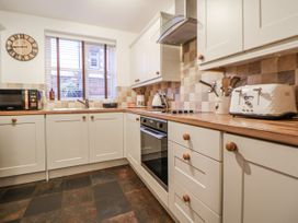 A kitchen featuring appliances and cabinets at The Stables in Prestatyn
