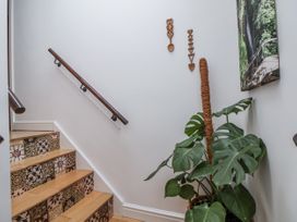A stairway with wooden steps and a plant at The Stables in Prestatyn