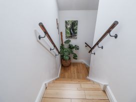 A staircase with wooden steps and a plant at The Stables in Prestatyn