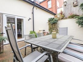 An outdoor dining area with a table and chairs at The Stables in Prestatyn