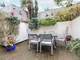 A garden with a table and chairs at The Stables in Prestatyn