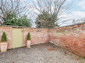 An outdoor area with a door and plants at The Stables in Prestatyn