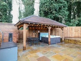 An outdoor area with a hot tub and seating at Park View Lodge